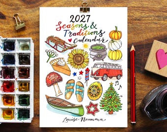 May include: A 2027 Seasons & Traditions calendar by Louise Neumann featuring colorful watercolor illustrations of a sled, sunflower, pumpkin stack, cauldron, pie, van, mushroom, sandals, egg, canoe, and Christmas tree on white paper.