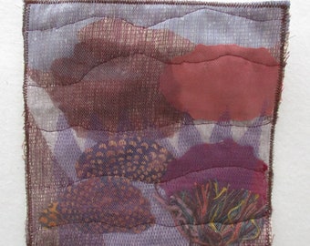 Nature wall art quilt,small handmade wall hanging,impressionistic view of a desert floor,hills,sheer fabric rocks and plants add texture