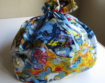 Fabric gift bag,extra large,cotton,medium blue,white,red,yellow,reusable,abstract design like marbling,coordinated blue ribbon wraps around,