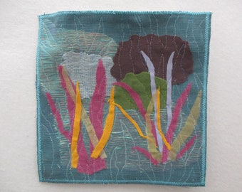 Nature wall art quilt,small handmade wall hanging, impressionistic view of a pond,rocks and plants,sheer fabrics add dimension and texture