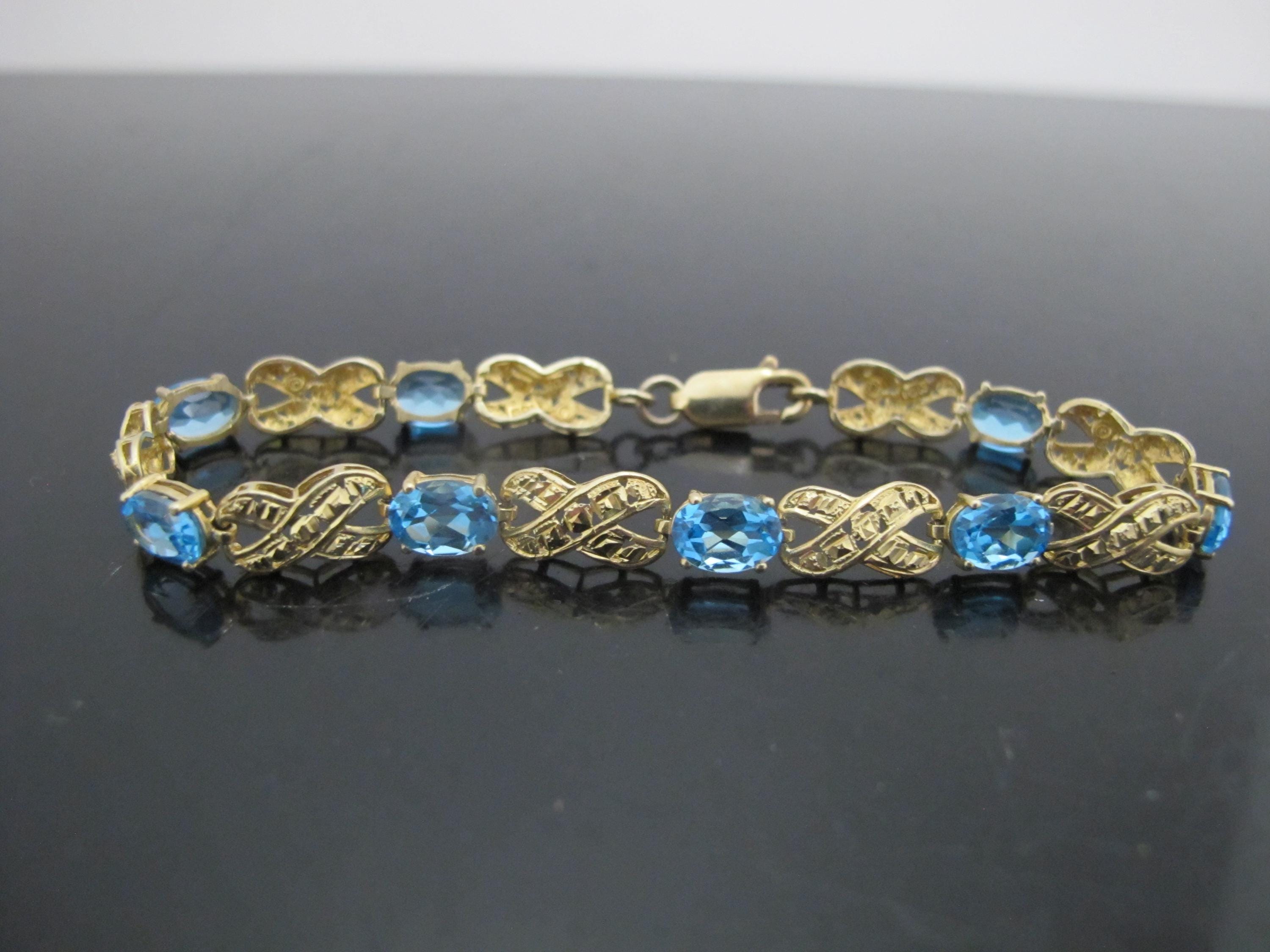 Blue TOPAZ 10k Yellow Gold XOXO Ribbon Link Tennis Bracelet