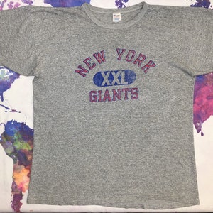 May include: Gray t-shirt with a blue and red graphic that says "NEW YORK XXL GIANTS".