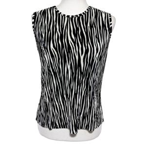 May include: Sleeveless top with a black and white zebra stripe pattern. The top has a round neckline and is displayed on a mannequin. The fabric appears to be lightweight and suitable for warm weather.