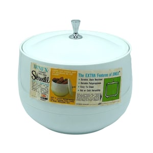 May include: A vintage Dinex Servall ice bucket, white with a silver handle. The bucket has a lid and a label with text about keeping food hot or cold. The label also lists features like scratch resistance and easy cleaning.
