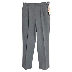 May include: Gray pleated trousers with a straight leg. The pants have a button and a tag attached. The fabric appears to be a medium-weight material. The trousers are a classic style.