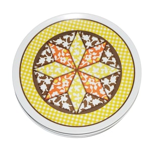May include: A stack of round coasters with a retro design. The coasters feature a white border, a yellow gingham pattern, and a central design with orange, yellow, and brown floral and geometric shapes.