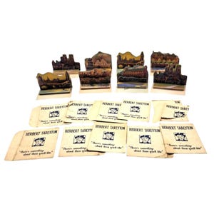 May include: A collection of vintage paper advertising pieces. The image features miniature landscape dioramas and small cards with the text "HERBERT TAREYTON" and the phrase "There's something about them you'll like."