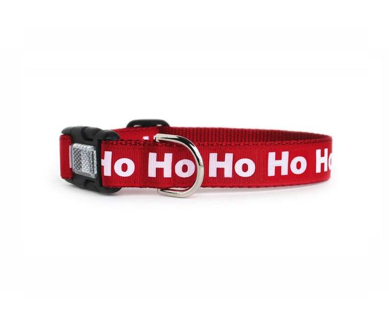 A red Christmas dog collar with white ho ho ho text and optional reflective buckle.
