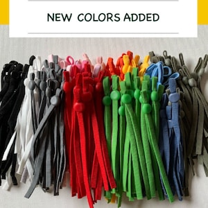 May include: A variety of colors of elastic cord with adjustable toggles. The colors include black, white, gray, red, green, blue, and brown.  New colors added.