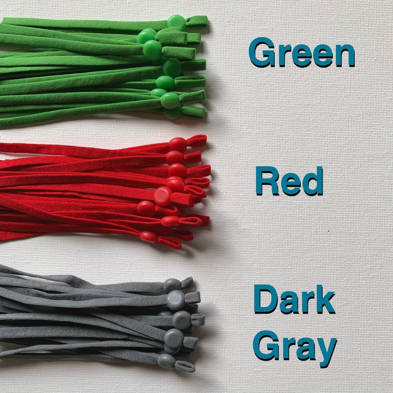 May include: Three bundles of elastic cord with adjustable toggles. The cords are green, red, and dark gray.