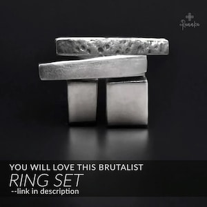 May include: A silver ring set with a brutalist design. The set includes two square-shaped rings and two rectangular rings. The top ring has a textured surface. The text "YOU WILL LOVE THIS BRUTALIST RING SET" is displayed at the bottom.