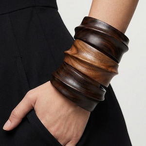 May include: A rustic wooden sign with the text "Welcome to our home" in white lettering. The sign features a distressed finish and a simple, inviting design, perfect for front door decor.