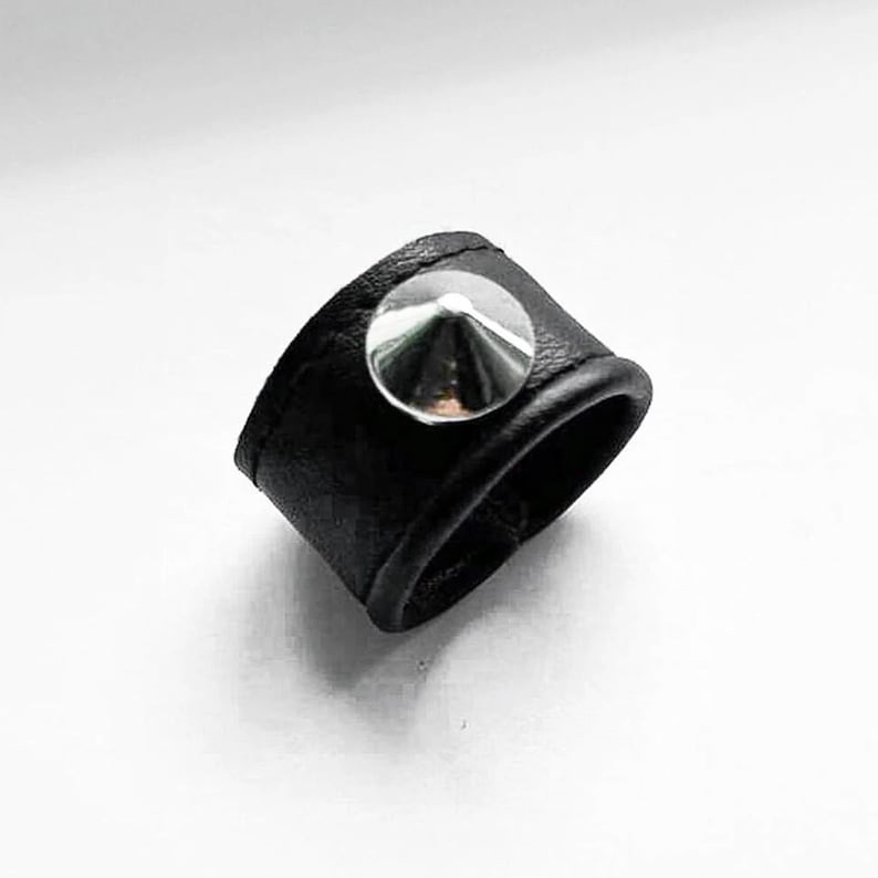 Spike Leather Ring Black Finger Cuff for him and for her - Black vegan leather ring with a single silver cone stud accent, minimalist punk-inspired design photographed on a clean white background, contemporary jewelry piece by Rannka.