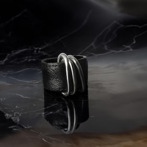 Avant-Garde Black Leather Ring is perfect for urban trendsetters seeking cutting-edge jewelry
