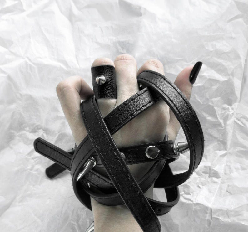 This ring combines vegan black faux leather with a statement cone stud, making it a versatile, modern piece for daily wear or special occasions