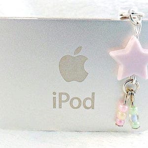 May include: A silver iPod with a pink star charm and a beaded dangle. The iPod has the Apple logo and the word "iPod" printed on it.