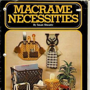 May include: A book cover with the title "Macrame Necessities" by Susan Shwartz. The cover features a variety of macrame projects, including a wall hanging, a plant hanger, a tissue box cover, a magazine rack, and a mirror. The book is from 1976 and includes 23 projects for every room of the house.