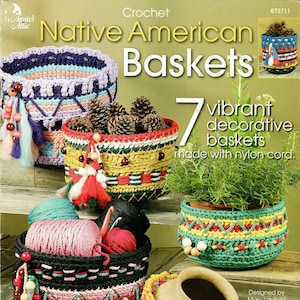 May include: Crochet pattern book for Native American baskets. The cover features seven colorful crocheted baskets made with nylon cord. The book is titled "Crochet Native American Baskets" and says "7 vibrant decorative baskets made with nylon cord".