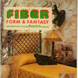 May include: A magazine cover for "Fiber Form & Fantasy" featuring a bedroom scene with a woven headboard, a lamp, and a quilted bedspread. The magazine cover text reads "New Methods for Macrame Enthusiasts".