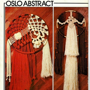 May include: Two macrame wall hangings with the text "Oslo Abstract" and "Scandinavian Sketch". The first wall hanging is red, white, and brown with a circular design. The second wall hanging is brown, white, and cream with a circular design.