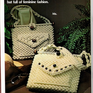 May include: Two crocheted handbags with wooden beads. The larger bag is beige and the smaller bag is white. Both bags have a flap closure and a beaded trim.