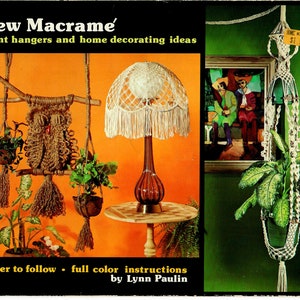 May include: A book cover with the title "New Macrame'" and a subtitle "plant hangers and home decorating ideas". The cover features three macrame plant hangers, a macrame lampshade, and a painting of two people. The book is by Lynn Paulin and costs $2.