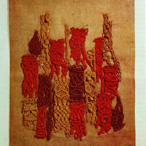 Peut inclure: Une tapisserie murale en fil noué dans des tons de rouge, orange et jaune. Le fil est disposé en une variété de motifs et de textures, créant une œuvre d'art visuellement intéressante et unique.