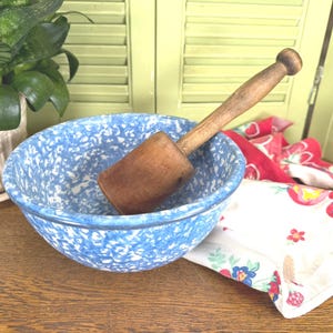 May include: A white ceramic mug with a black handle and the text "But First, Coffee" in a handwritten style. The mug is on a white surface. The mug is approximately 4 inches tall.