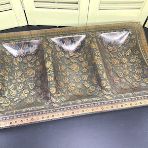 May include: A clear glass serving dish with three sections. The dish has a gold and black floral pattern around the edge and on the bottom.