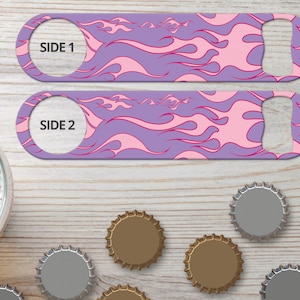 May include: Purple and pink bottle opener with a flame pattern. The opener has a side 1 and side 2 label.