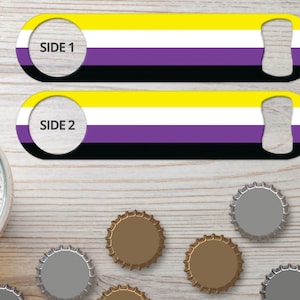 May include: Two metal bottle openers with a yellow, white, purple, and black design. The design is similar to the non-binary pride flag. The text "Side 1" and "Side 2" are printed on the openers.