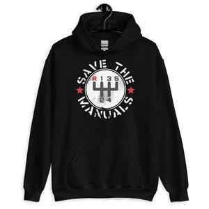May include: Black hoodie with a white circle graphic that says "Save The Manuals" with a red star on each side of the circle. The graphic also includes a vintage-style gear shift pattern with the letters R, 1, 3, 5, 2, and 4.