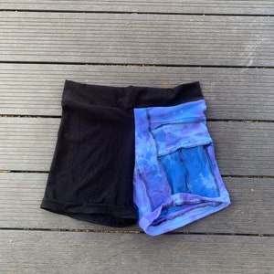 May include: Black and blue tie-dye shorts with a black waistband and a pocket on each side.