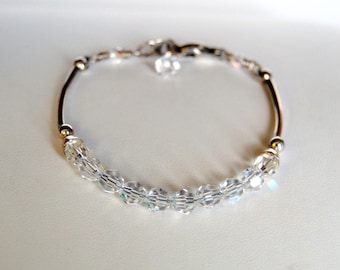 May include: A silver bracelet with a row of clear crystal beads.