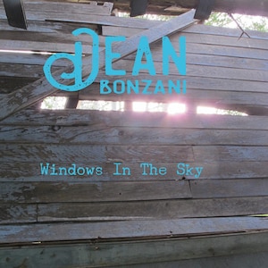 May include: A weathered wooden wall with a hole in it, revealing a bright sky. The words "DEAN BONZANI" and "Windows In The Sky" are written in blue on the wall.