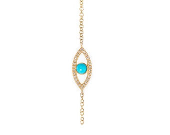 May include: A gold chain bracelet with a turquoise stone set in a diamond-encrusted eye shape pendant.