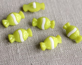 May include: Assortment of six lime green candy buttons with white stripes. The buttons are shaped like candy and have a glossy finish.
