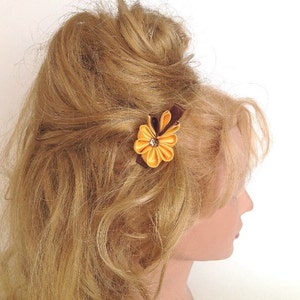 Yellow kanzashi flower hair clip with a hint of brown