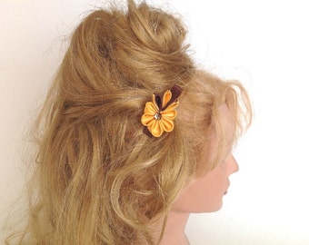 Yellow kanzashi flower hair clip with a hint of brown