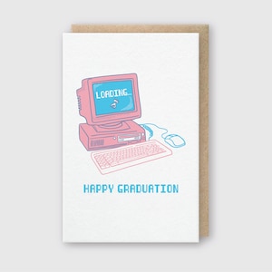 May include: A pink and blue illustrated greeting card with a computer screen that says "LOADING..." and a keyboard and mouse. The text "HAPPY GRADUATION" is below the computer.