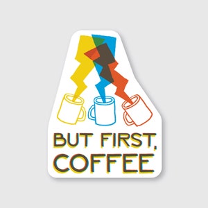 May include: A white sticker with a coffee theme. The sticker features three coffee mugs with colorful lightning bolt-like streams. The text "BUT FIRST, COFFEE" is displayed in a layered, colorful font.