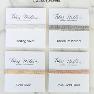 May include: Four white cards with the text "Blair Nadean bridal adornments" on each card. Each card shows a different chain style in sterling silver, rhodium plated, gold filled, and rose gold filled.