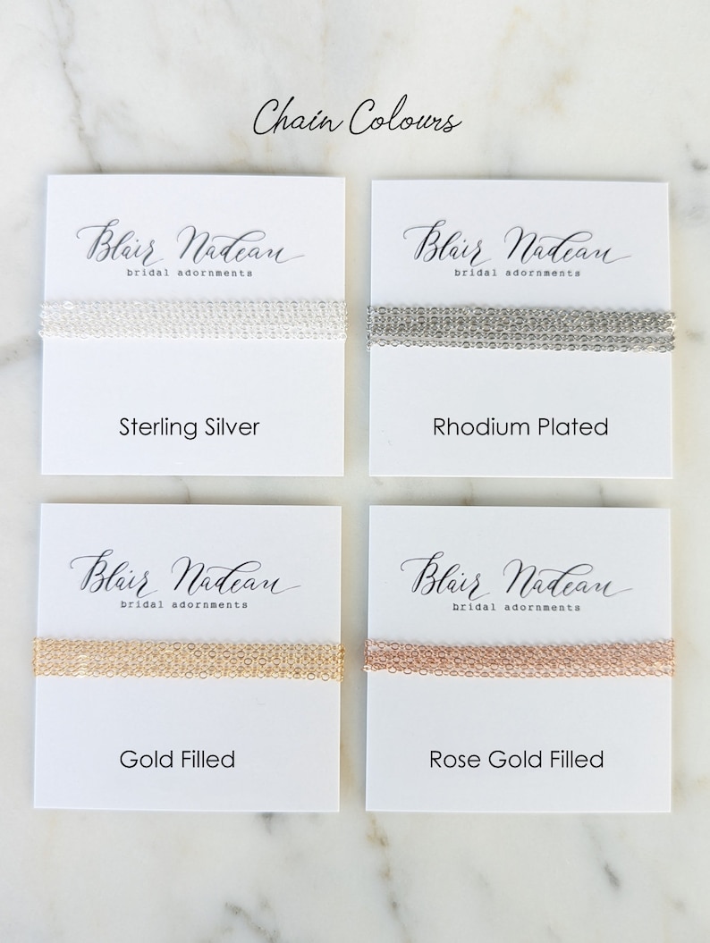 May include: Four white cards with the text "Blair Nadean bridal adornments" on each card. Each card shows a different chain style in sterling silver, rhodium plated, gold filled, and rose gold filled.