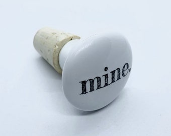 mine. white ceramic + black print wine stopper