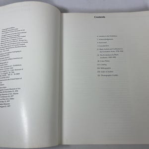 May include: An open book showing the copyright page on the left and the contents page on the right. The text includes details about the publication Two Centuries of Black American Art, exhibition dates, and a list of chapters starting with Lenders to the Exhibition, Acknowledgements, Foreword, and Introduction.