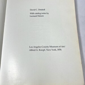 May include: A white title page from the book Two Centuries of Black American Art by David C. Driskell, with catalog notes by Leonard Simon, published by the Los Angeles County Museum of Art and Alfred A. Knopf in New York in the year 1976.