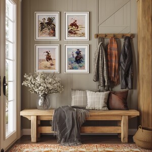 May include: A wooden bench with a gray throw blanket and pillows sits in a room with a patterned rug. Four framed pictures of cowboys on horseback hang on the wall above the bench. A coat rack with several coats hangs on the wall to the right of the bench.