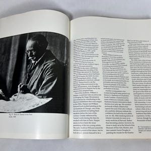 May include: An open book featuring a black and white photograph of an artist holding a paintbrush and palette on the left page, with printed text columns on the right page. The caption below the image reads, Fig. 37: Henry O. Tanner in his Paris studio, 1939.