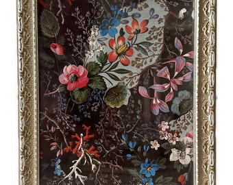 May include: A framed print of a floral pattern with red, pink, blue, and yellow flowers on a dark background.