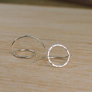 Two silver circle hoop earrings, with a shiny hammered finish.